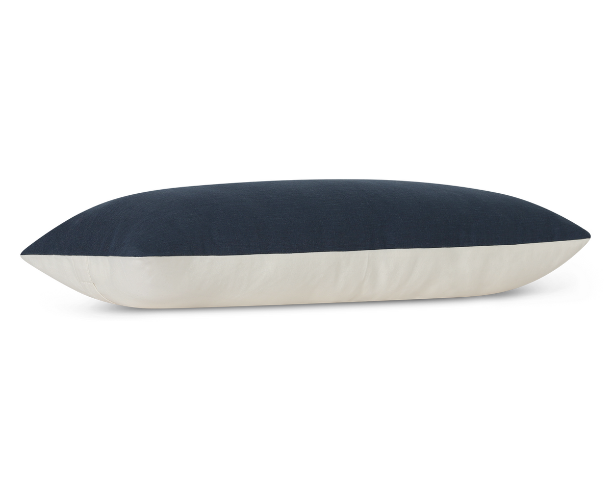 Solid navy linen long lumbar pillow cover, side view showing the cream cotton back