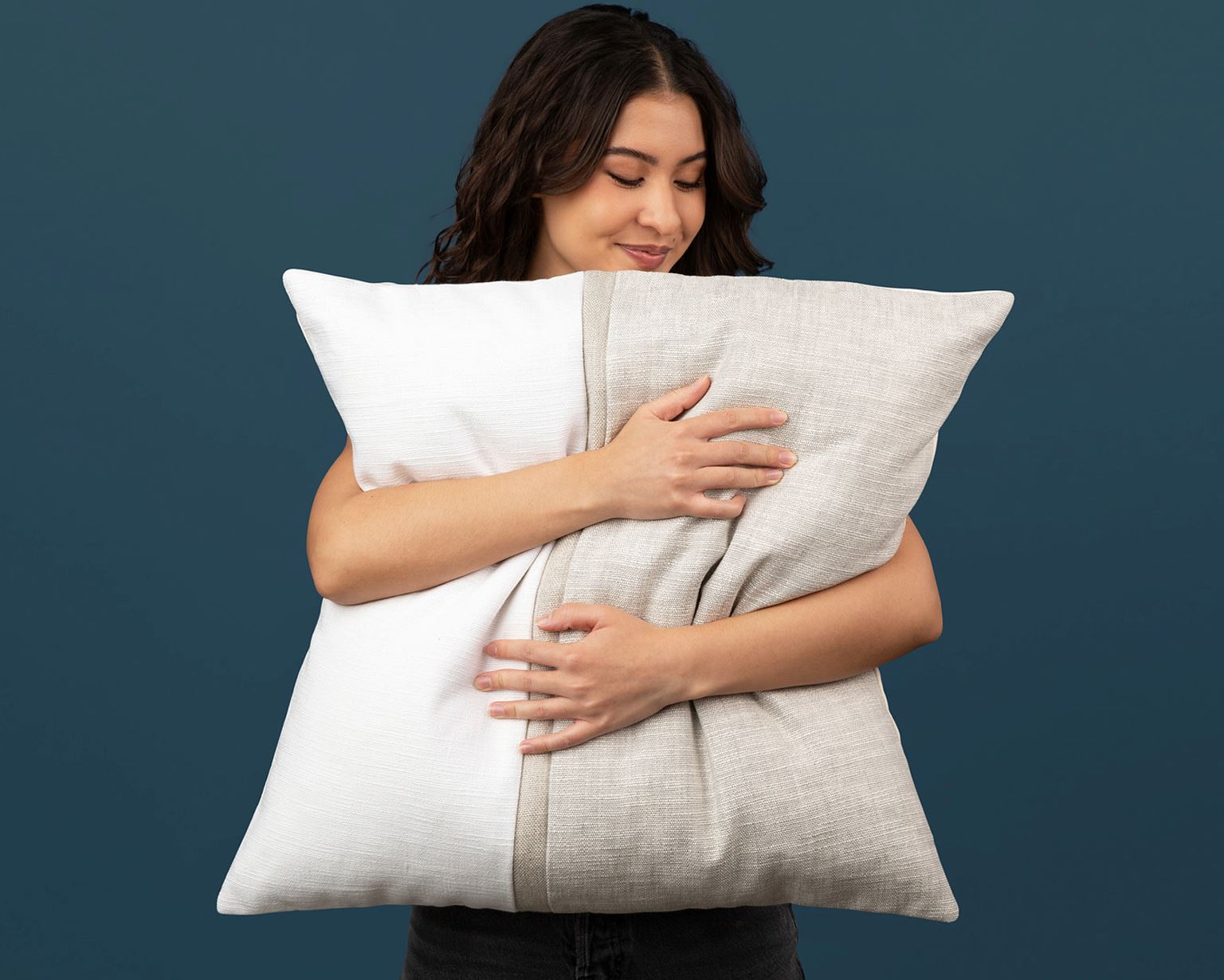 24x24 pillow cover filled with a 26x26 insert, shown at scale in a model's arms