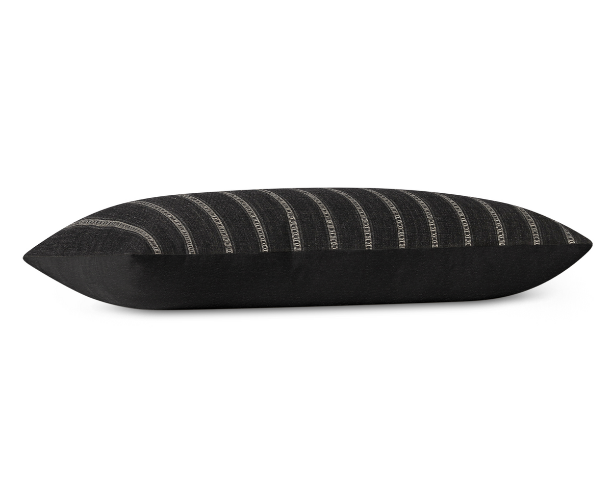 Taos in Onyx long lumbar pillow cover laid flat, charcoal black with khaki ladder stripes and a black cotton back